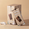 Box of 12 55% dark chocolate coconut protein bars with shredded coconut and no added sugar