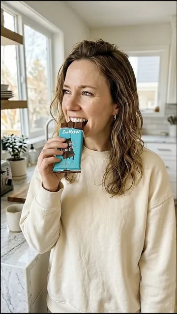ZoRaw customer holding protein chocolate bars